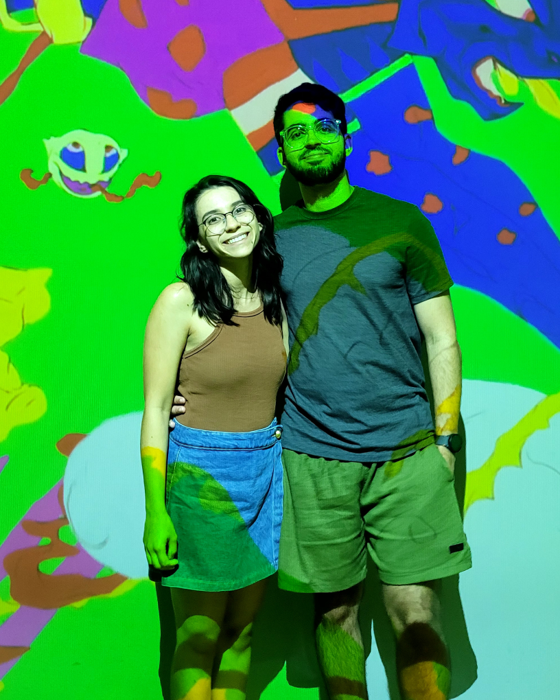 Matheus and his wife at a colorful art installation